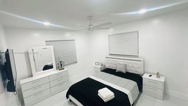a bedroom with a bed and a large mirror