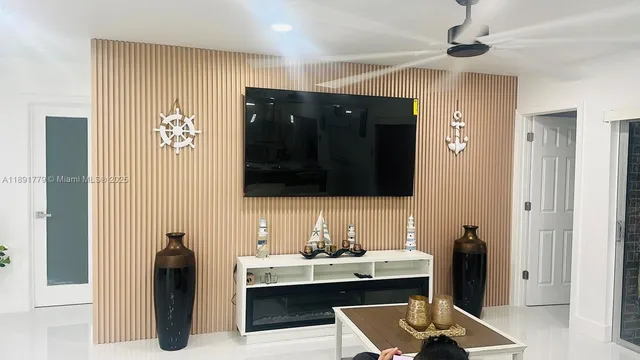 a living room with furniture and a flat screen tv