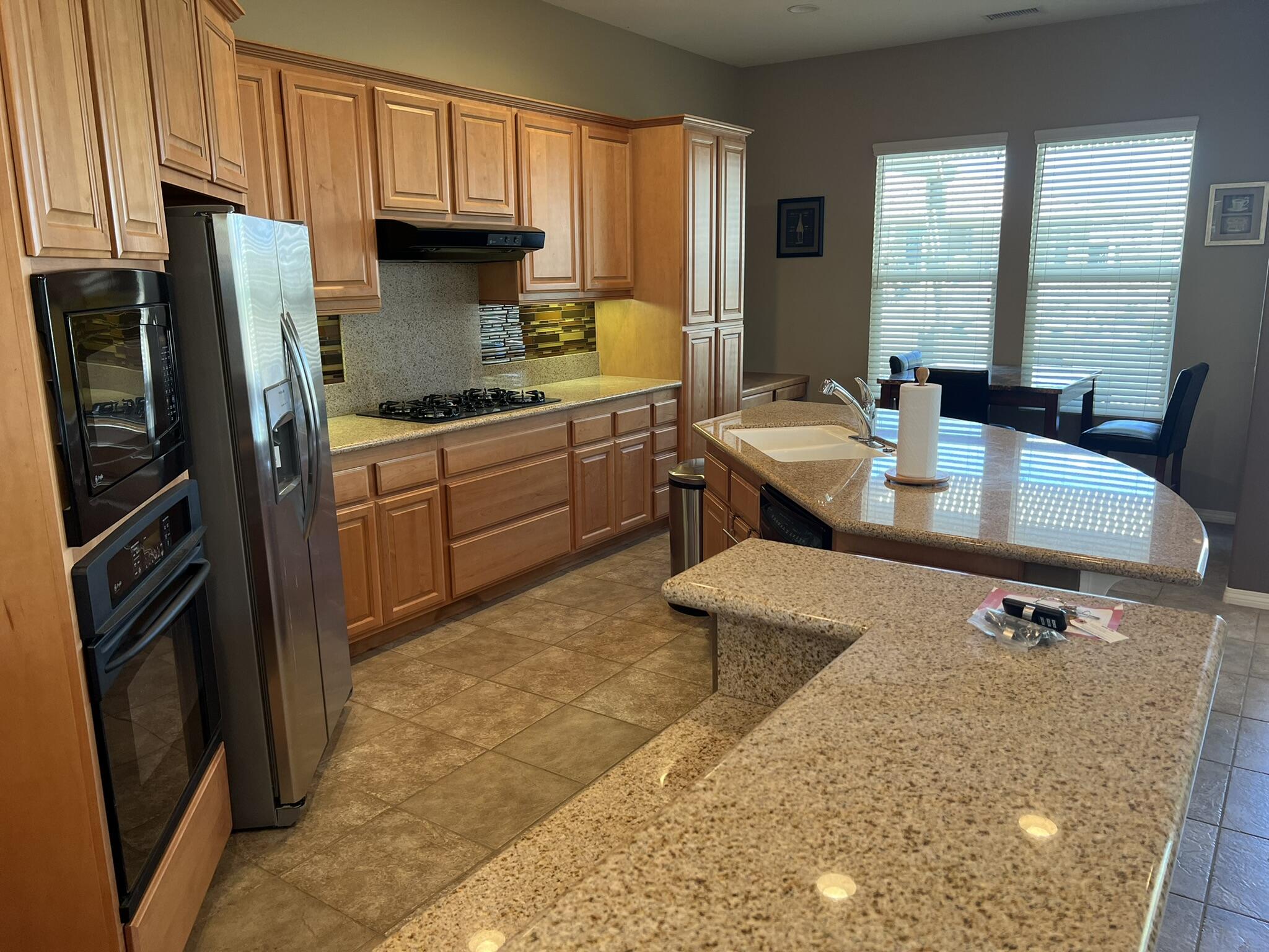 59 Shoreline Drive Rancho Mirage, CA 92270 - Photo 21 of 56 a kitchen with stainless steel appliances granite countertop a refrigerator a stove and a sink dishwasher