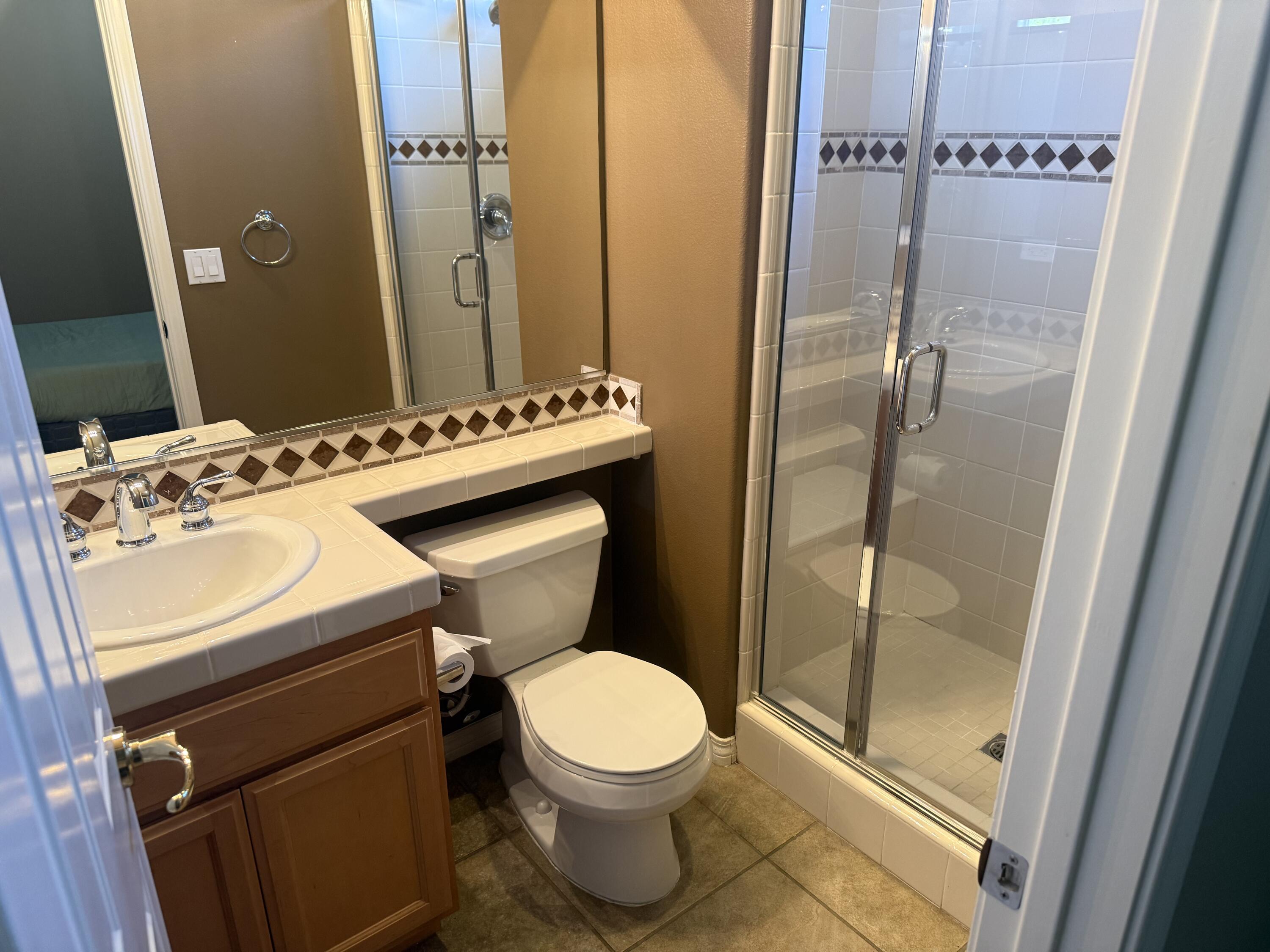 59 Shoreline Drive Rancho Mirage, CA 92270 - Photo 30 of 56 a bathroom with a sink a toilet and shower