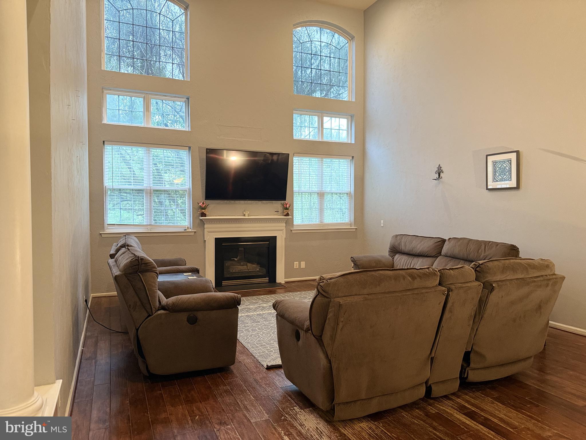 135 Juniper Lane Swedesboro, NJ 08085 - Photo 12 of 40 a living room with furniture a flat screen tv and a fireplace