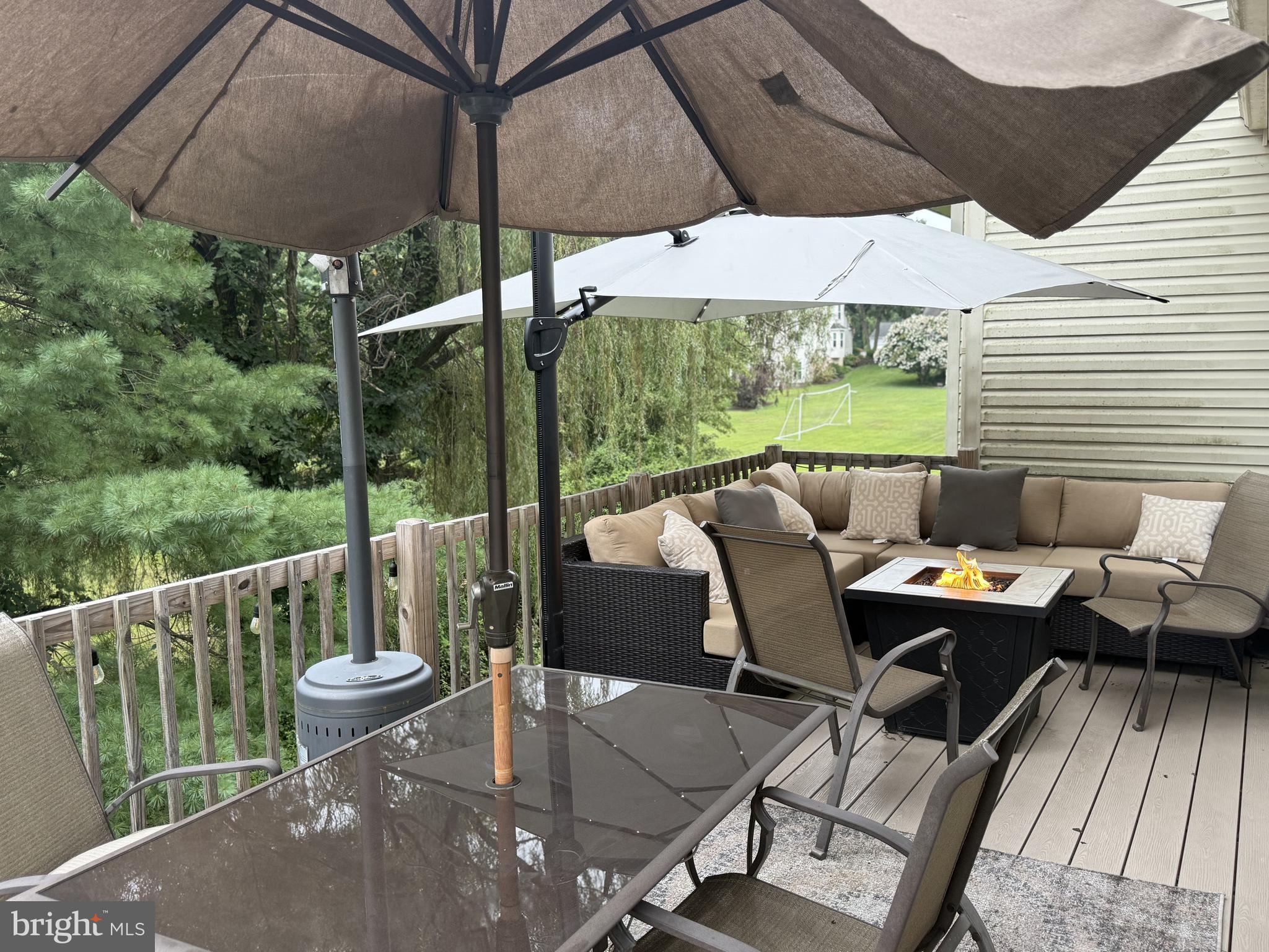 135 Juniper Lane Swedesboro, NJ 08085 - Photo 18 of 40 a roof deck with table and chairs under an umbrella