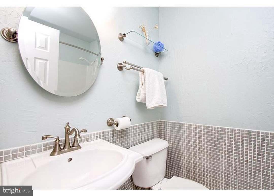 135 Juniper Lane Swedesboro, NJ 08085 - Photo 31 of 40 a bathroom with a sink a mirror and lamp