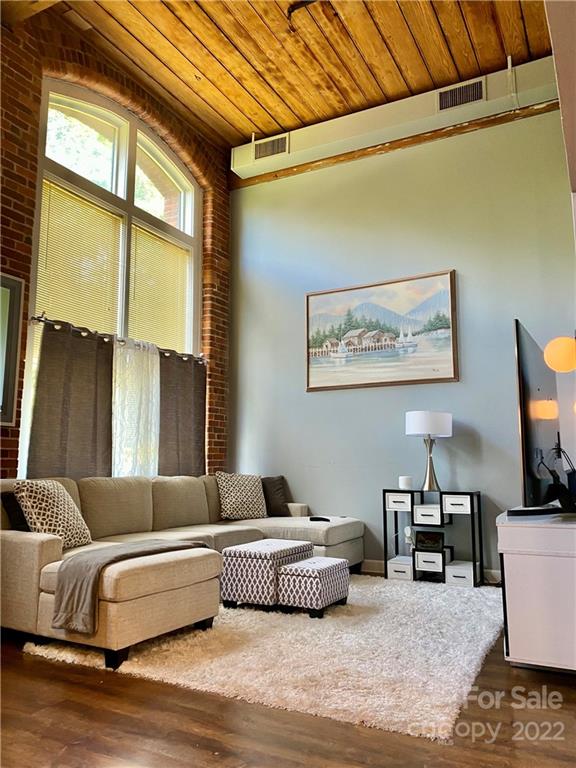201 South Hoskins Road, Unit 326 Charlotte, NC 28208 - Photo 1 of 18 a bedroom with furniture and a large window
