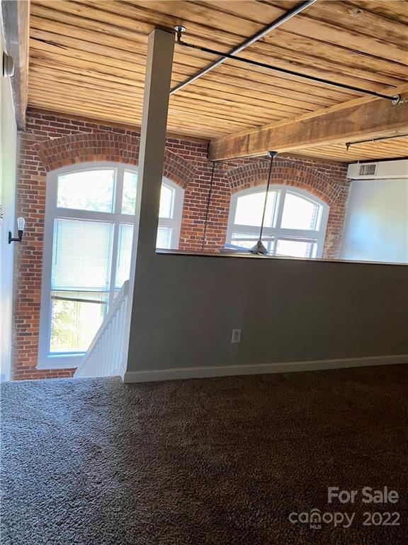 201 South Hoskins Road, Unit 326 Charlotte, NC 28208 - Photo 11 of 18 an empty room with wooden floor and windows