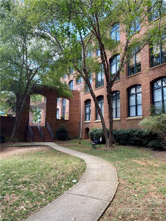 201 South Hoskins Road, Unit 326 Charlotte, NC 28208 - Photo 17 of 18 a view of a house with a yard