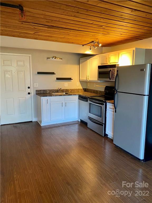 201 South Hoskins Road, Unit 326 Charlotte, NC 28208 - Photo 3 of 18 a kitchen with stainless steel appliances granite countertop a refrigerator a stove and a wooden floors