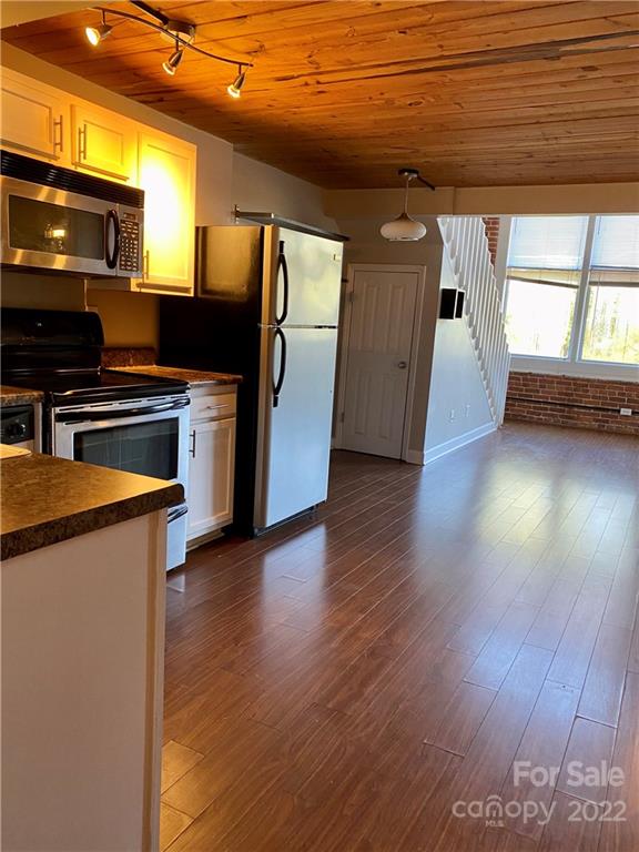 201 South Hoskins Road, Unit 326 Charlotte, NC 28208 - Photo 5 of 18 a kitchen with stainless steel appliances wooden floors and a view of living room