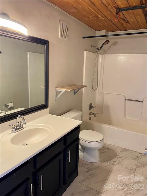 201 South Hoskins Road, Unit 326 Charlotte, NC 28208 - Photo 6 of 18 a bathroom with a sink a toilet a mirror and shower