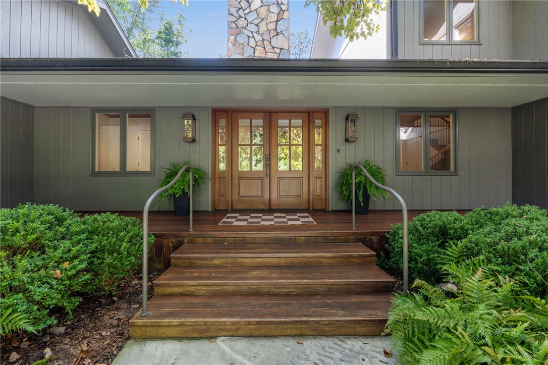 604 Ridgecrest Drive Clemson, SC 29631 - Photo 8 of 50 Warm wood doors invite entry onto a covered front porch framed by natural landscaping.