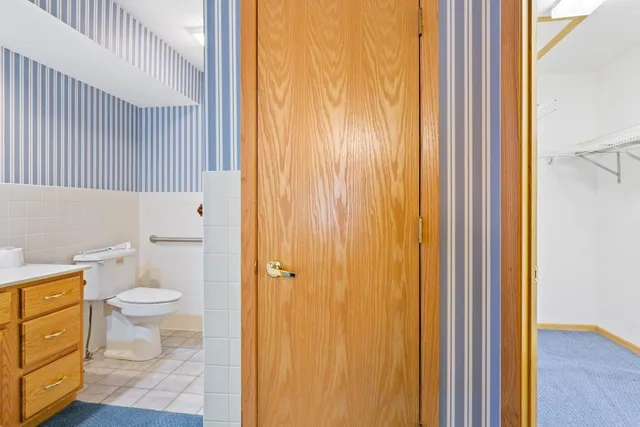 a bathroom with a toilet and a shower curtain