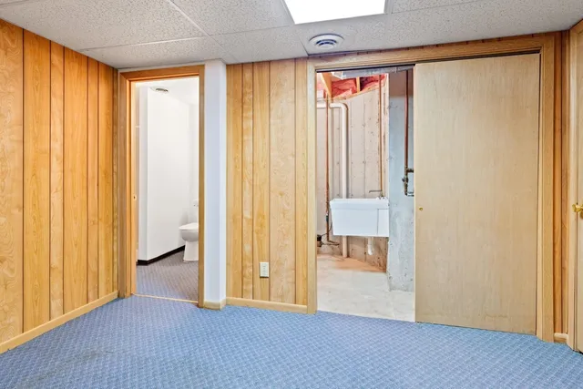 an entryway with wooden floor and a window