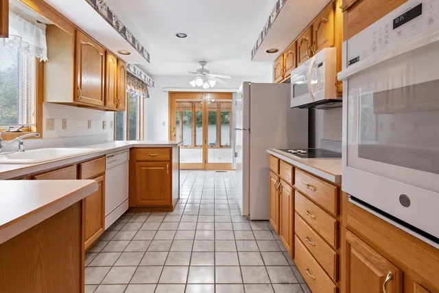 a kitchen with stainless steel appliances a sink stove and cabinets