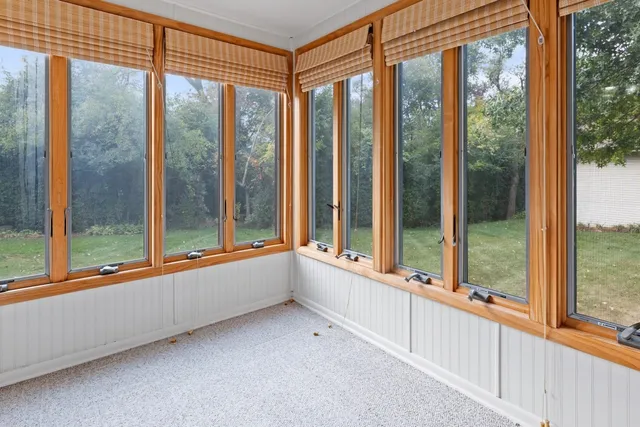 a view of an empty room with large windows