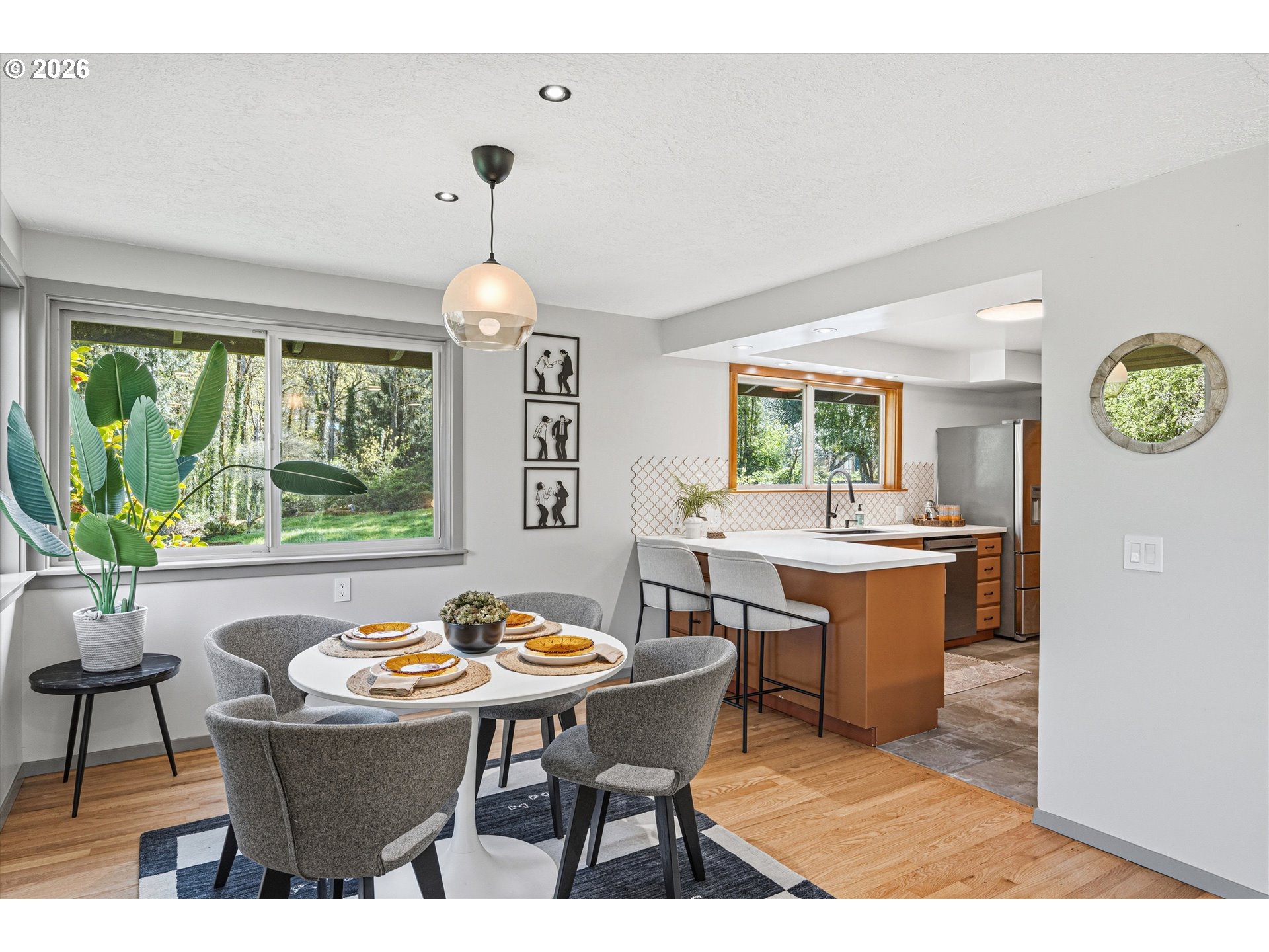 12802 Southeast Knapp Street Portland, OR 97236 - Photo 12 of 48 a dining room with a window a table and chairs