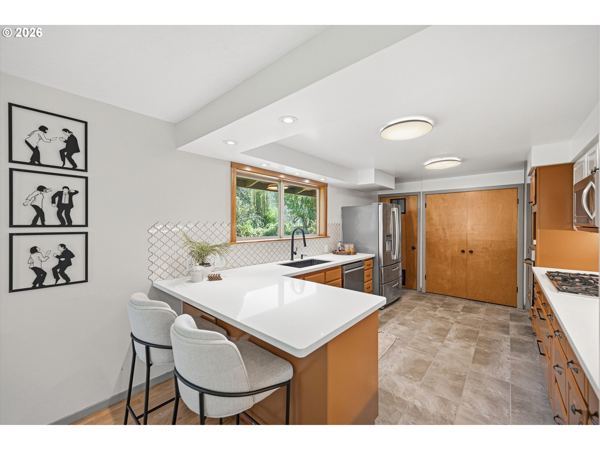 12802 Southeast Knapp Street Portland, OR 97236 - Photo 13 of 48 a living room with stainless steel appliances kitchen island granite countertop furniture and a large window