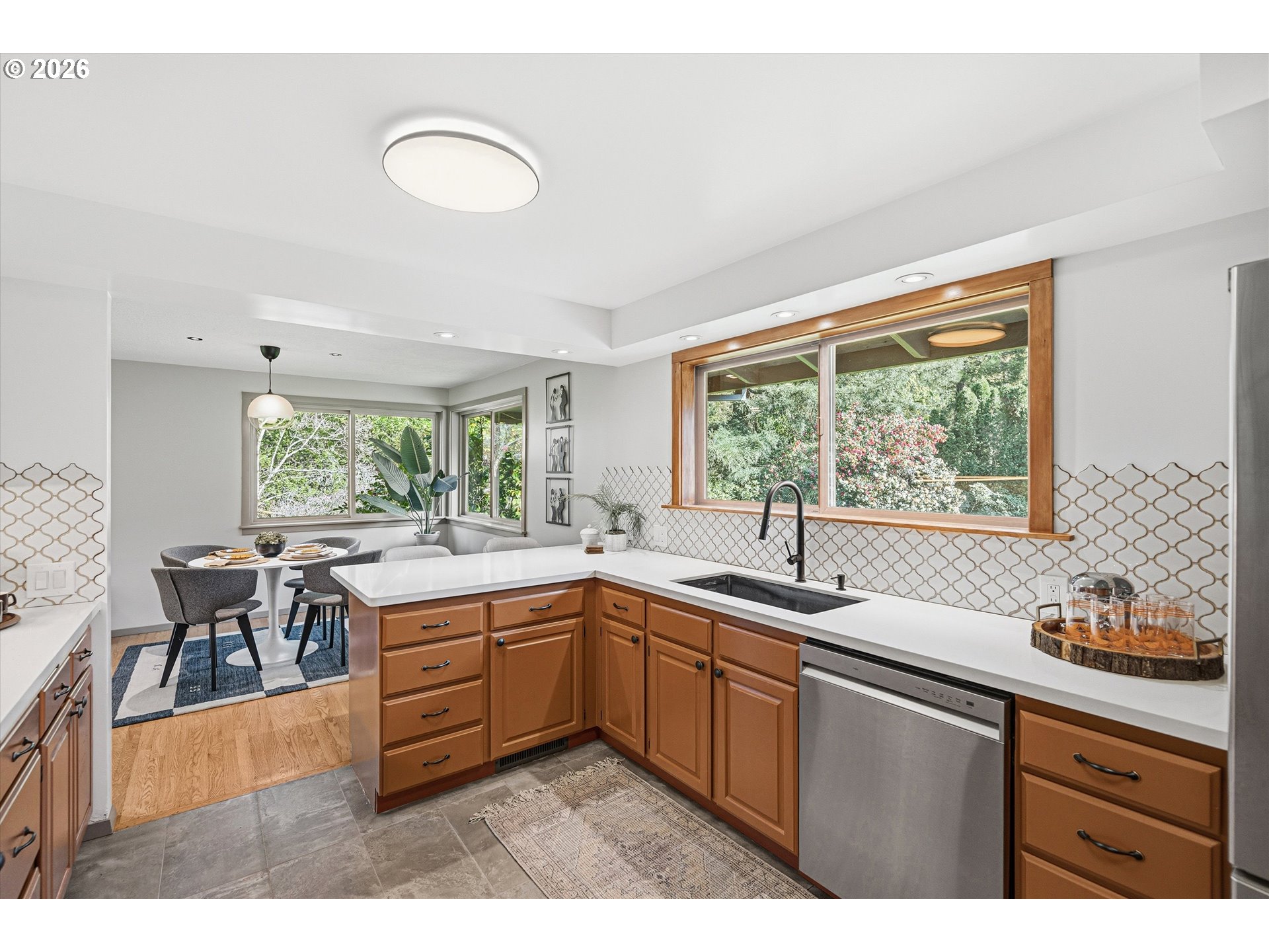 12802 Southeast Knapp Street Portland, OR 97236 - Photo 15 of 48 a kitchen with a sink and wooden cabinets