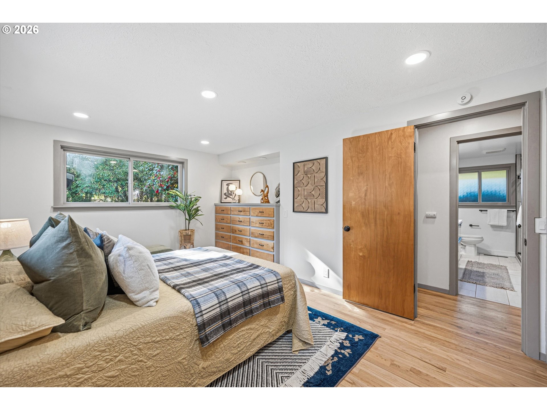 12802 Southeast Knapp Street Portland, OR 97236 - Photo 22 of 48 a bedroom with a bed and wooden floor