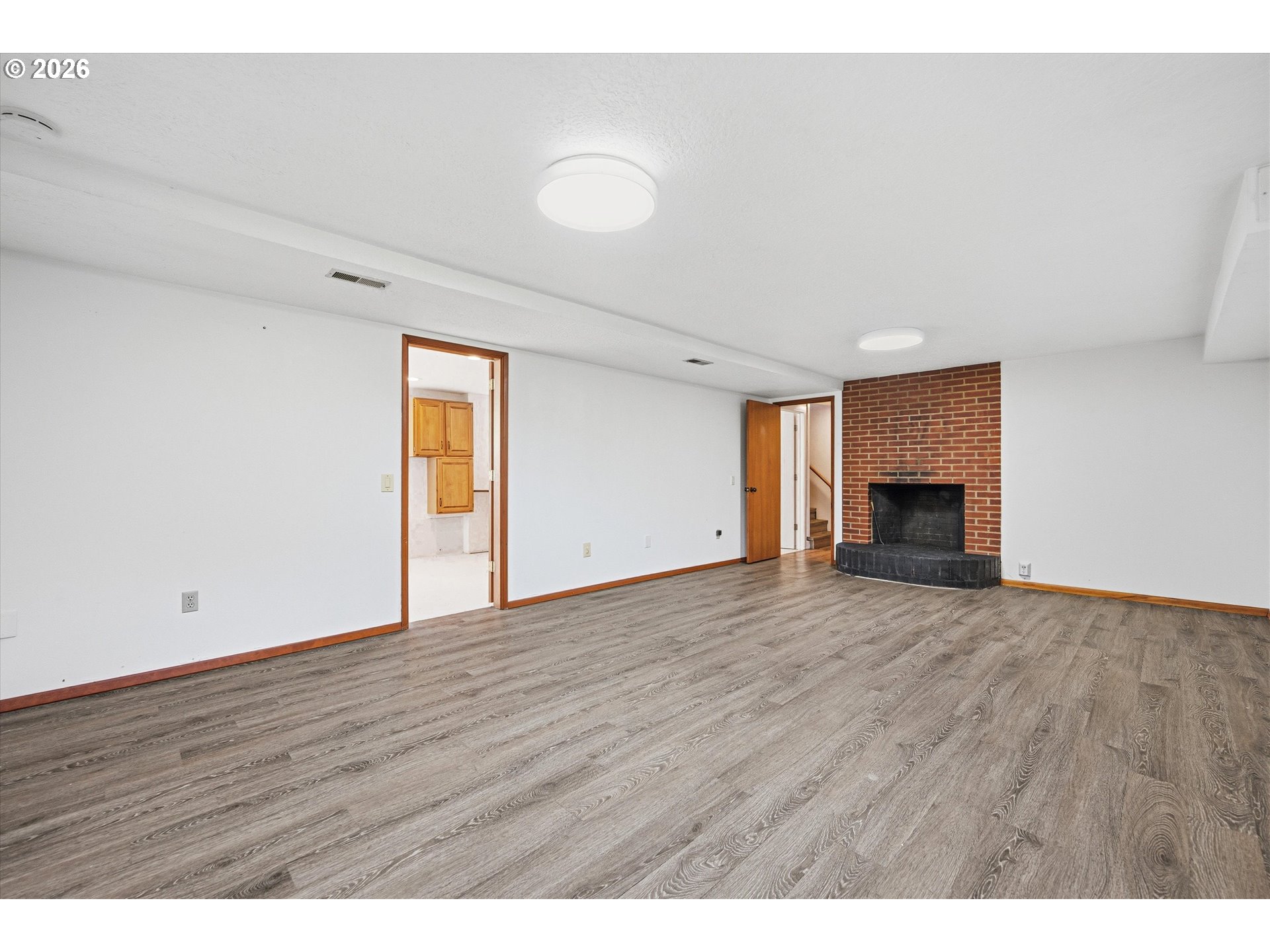 12802 Southeast Knapp Street Portland, OR 97236 - Photo 29 of 48 a view of an empty room with wooden floor and a window