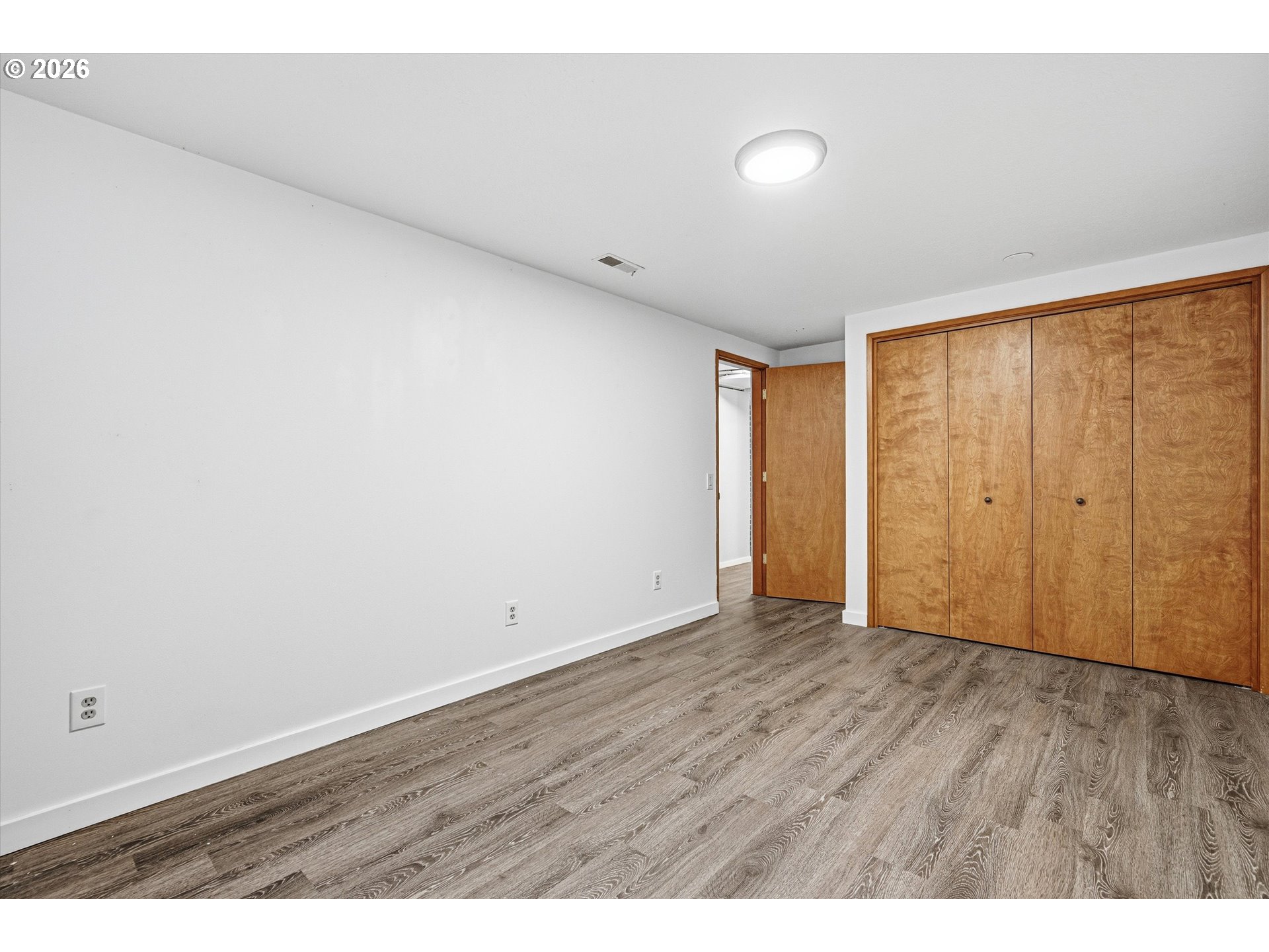 12802 Southeast Knapp Street Portland, OR 97236 - Photo 31 of 48 a view of an empty room with wooden floor