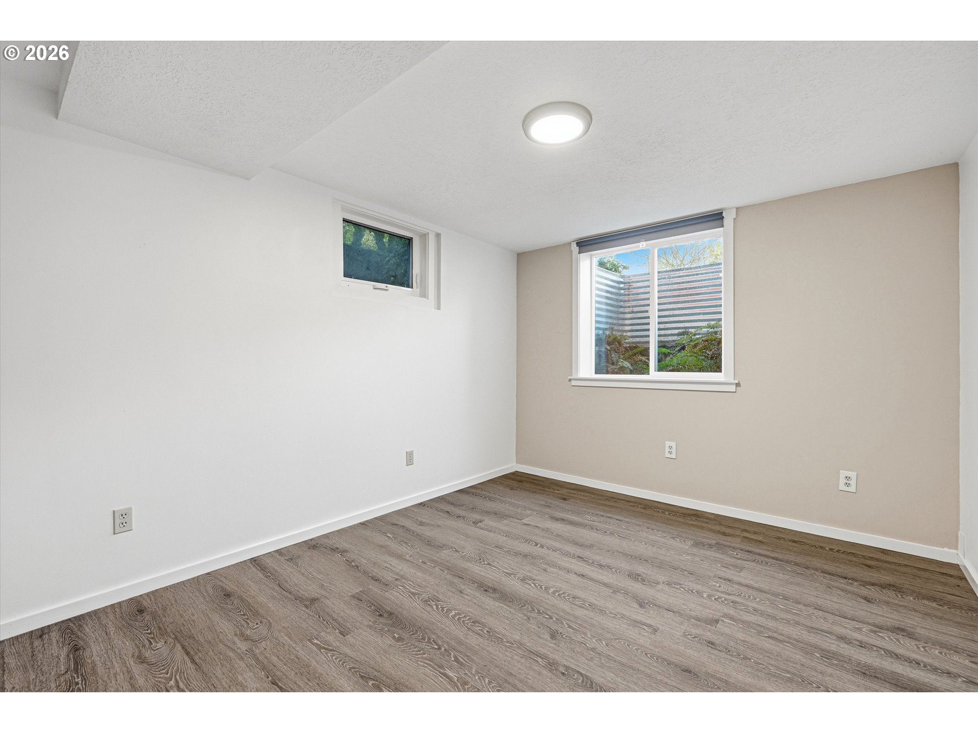 12802 Southeast Knapp Street Portland, OR 97236 - Photo 32 of 48 an empty room with wooden floor and windows