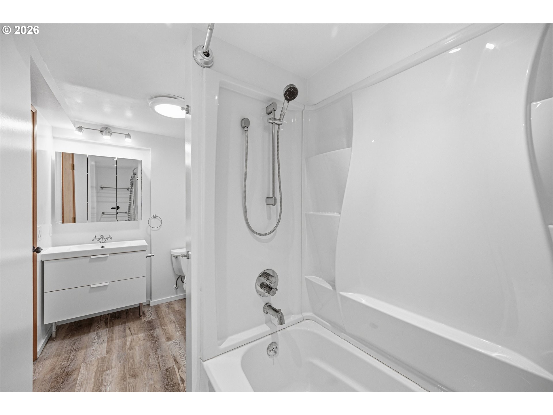 12802 Southeast Knapp Street Portland, OR 97236 - Photo 35 of 48 a bathroom with a granite countertop sink a mirror a vanity and shower
