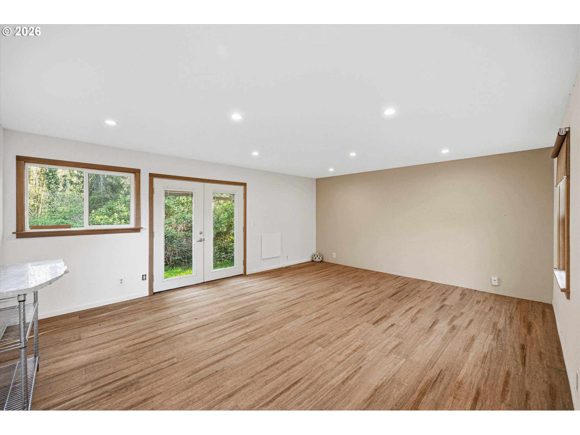 12802 Southeast Knapp Street Portland, OR 97236 - Photo 39 of 48 a view of an empty room with wooden floor and a window