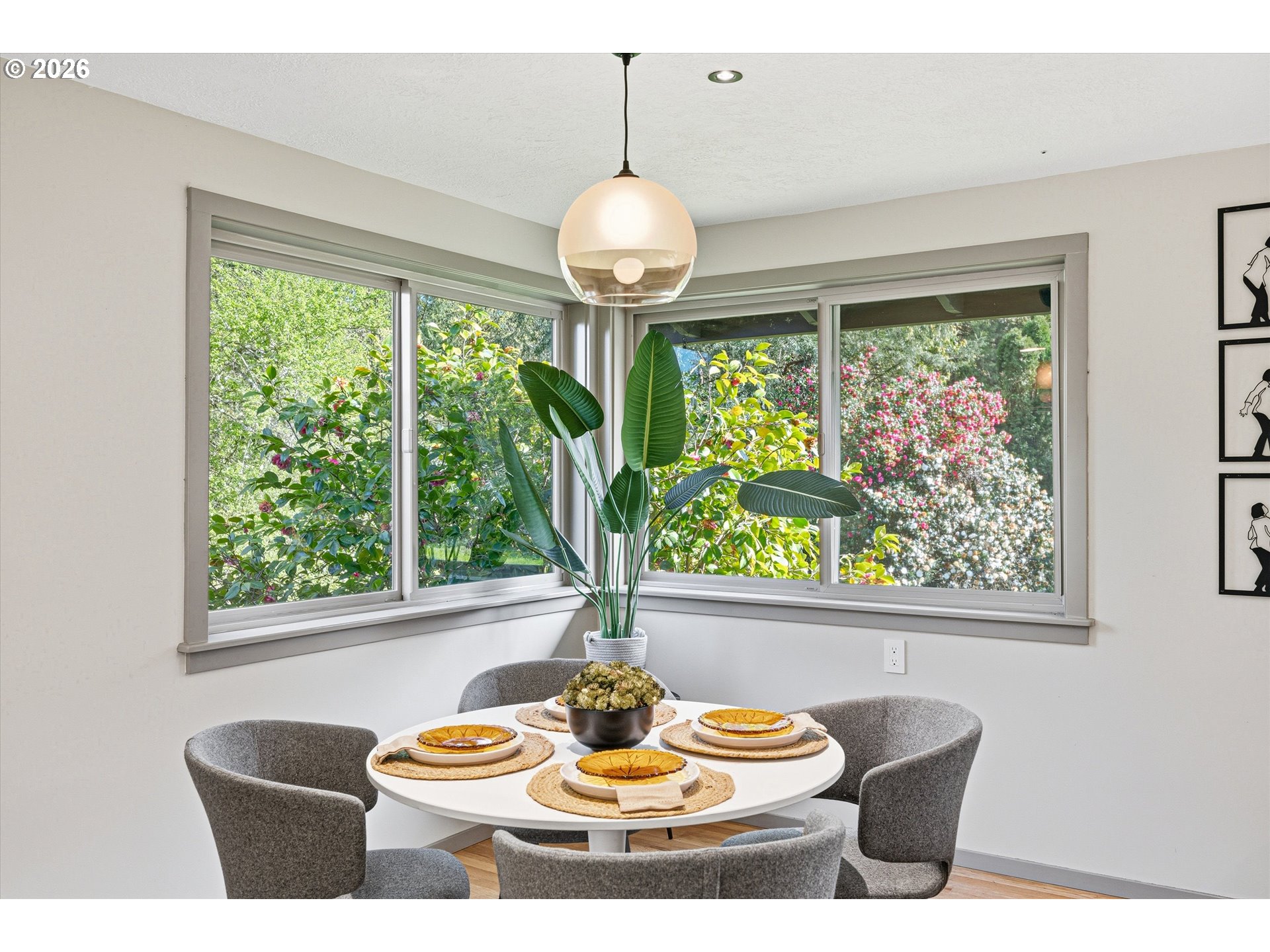 12802 Southeast Knapp Street Portland, OR 97236 - Photo 10 of 48 a dining room with furniture a chandelier and large windows