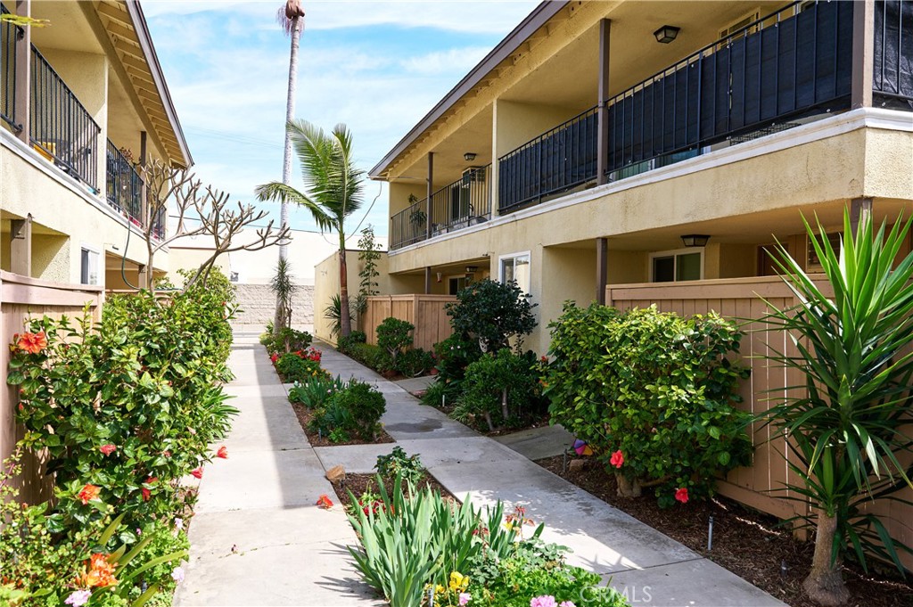 12310 La Pomelo Road La Mirada, CA 90638 - Photo 4 of 30 a view of a pathway with house and flower plants