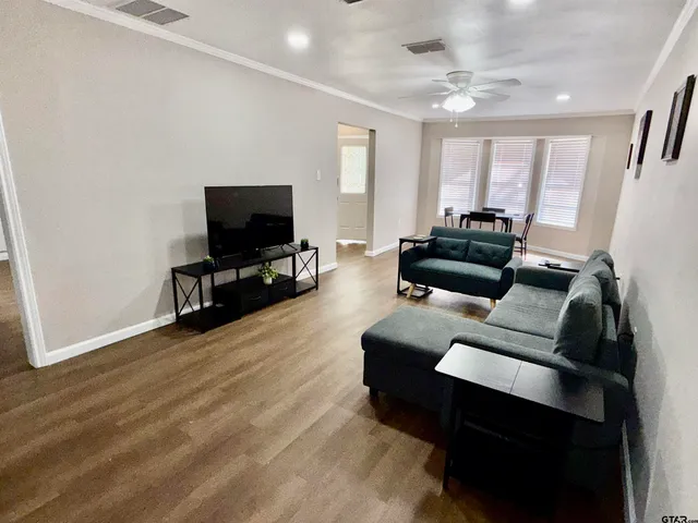 a living room with furniture and a flat screen tv