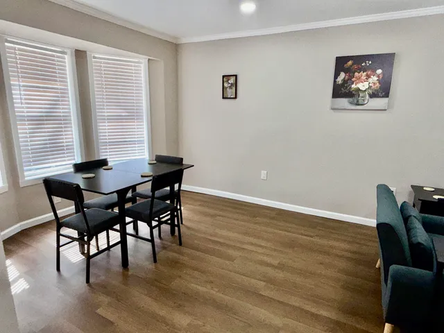 a view of a dining room with furniture and wooden floor