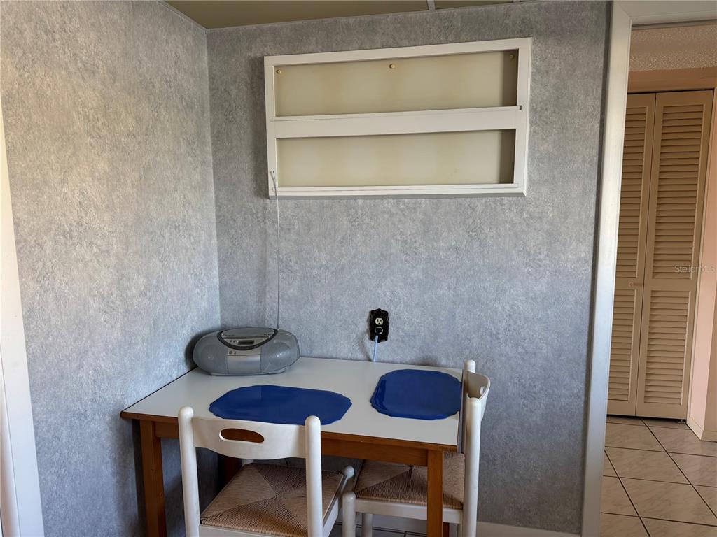 4775 Cove Circle, Unit 403 St. Petersburg, FL 33708 - Photo 11 of 42 a bathroom with a sink a chair and a toilet