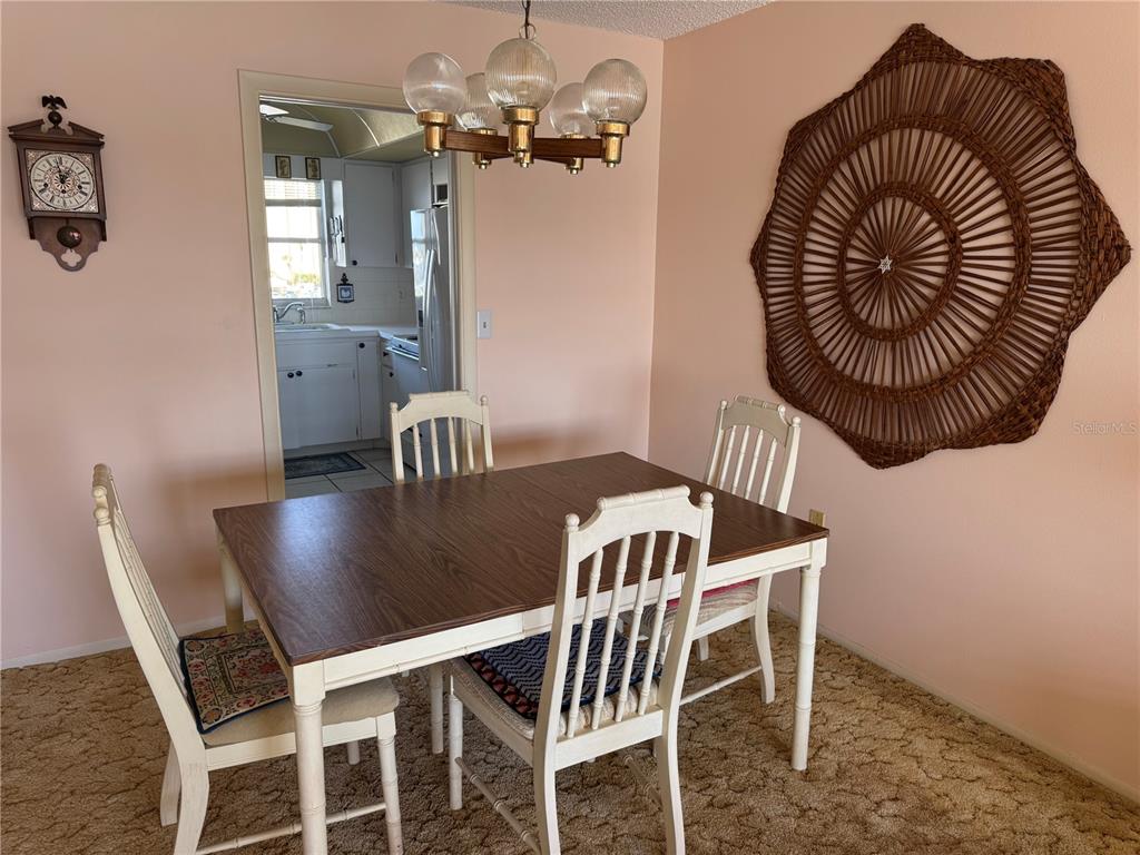 4775 Cove Circle, Unit 403 St. Petersburg, FL 33708 - Photo 12 of 42 a view of a dining room with furniture and wooden floor