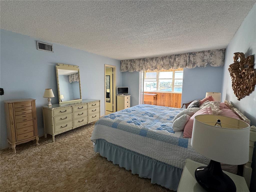 4775 Cove Circle, Unit 403 St. Petersburg, FL 33708 - Photo 15 of 42 a bedroom with bed and window