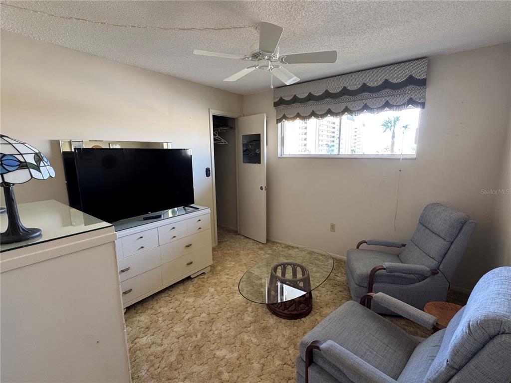4775 Cove Circle, Unit 403 St. Petersburg, FL 33708 - Photo 18 of 42 a living room with furniture and a flat screen tv