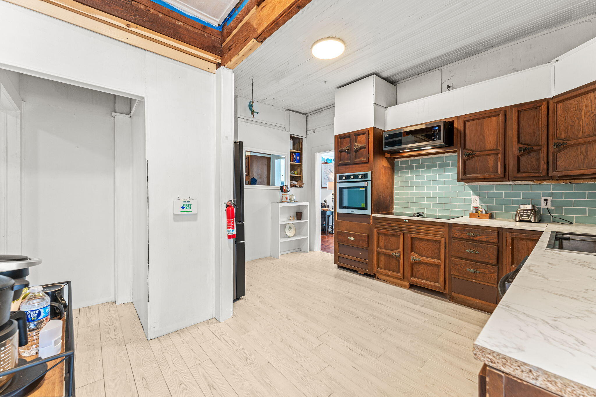 1365 Pineapple Avenue Melbourne, FL 32935 - Photo 16 of 46 a kitchen with stainless steel appliances granite countertop a refrigerator and a stove top oven