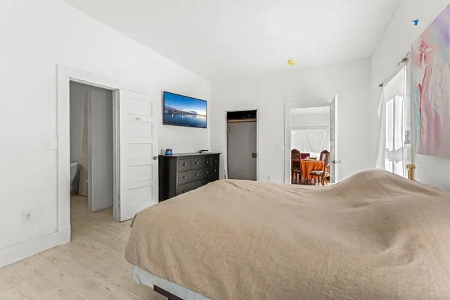 a bedroom with a bed and a dresser