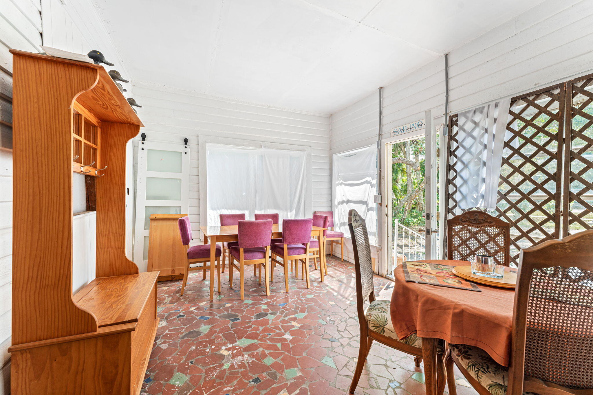 1365 Pineapple Avenue Melbourne, FL 32935 - Photo 38 of 46 a dining room with furniture a chandelier and wooden floor
