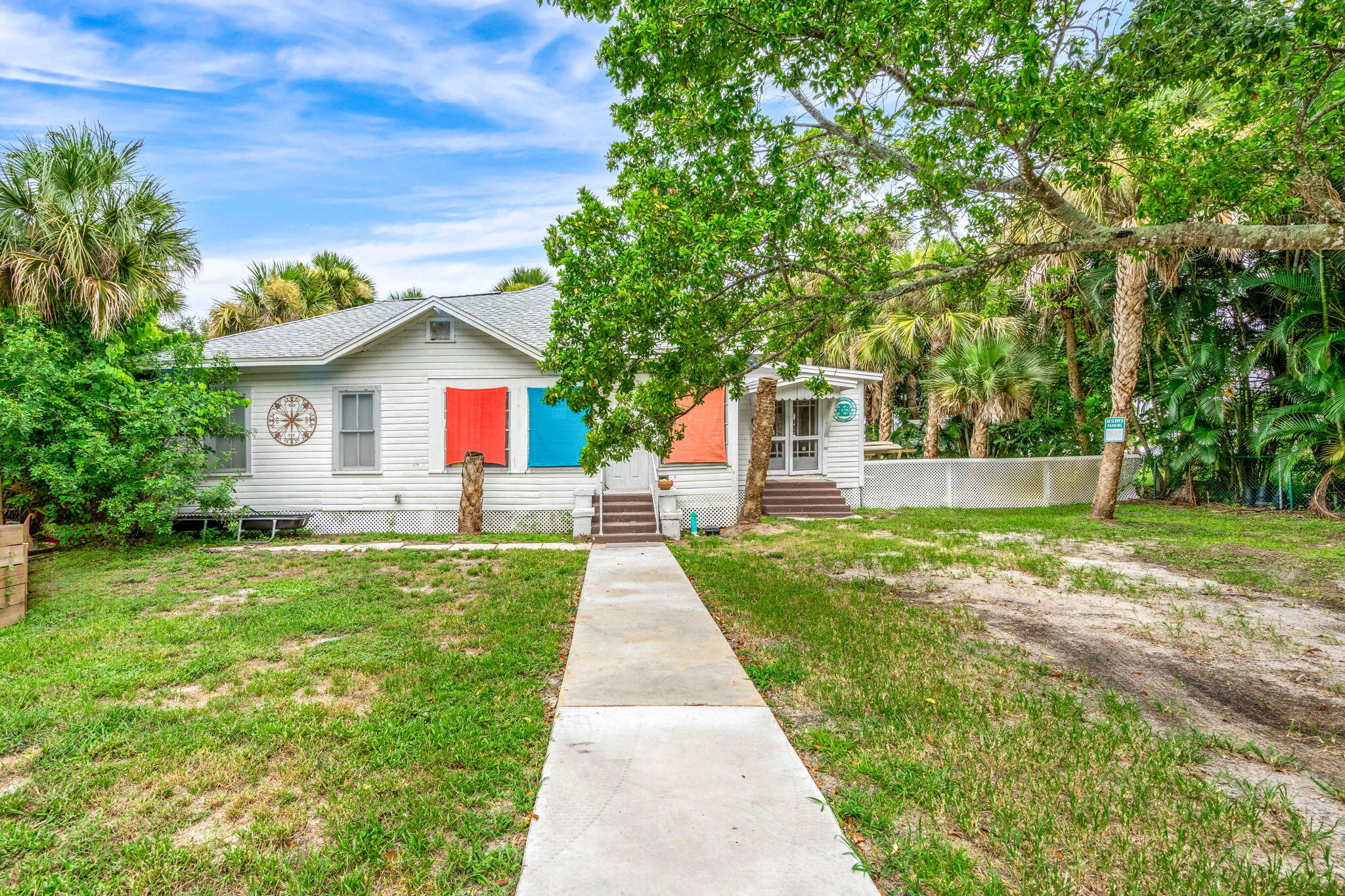 1365 Pineapple Avenue Melbourne, FL 32935 - Photo 8 of 46 a front view of a house with a yard and garage