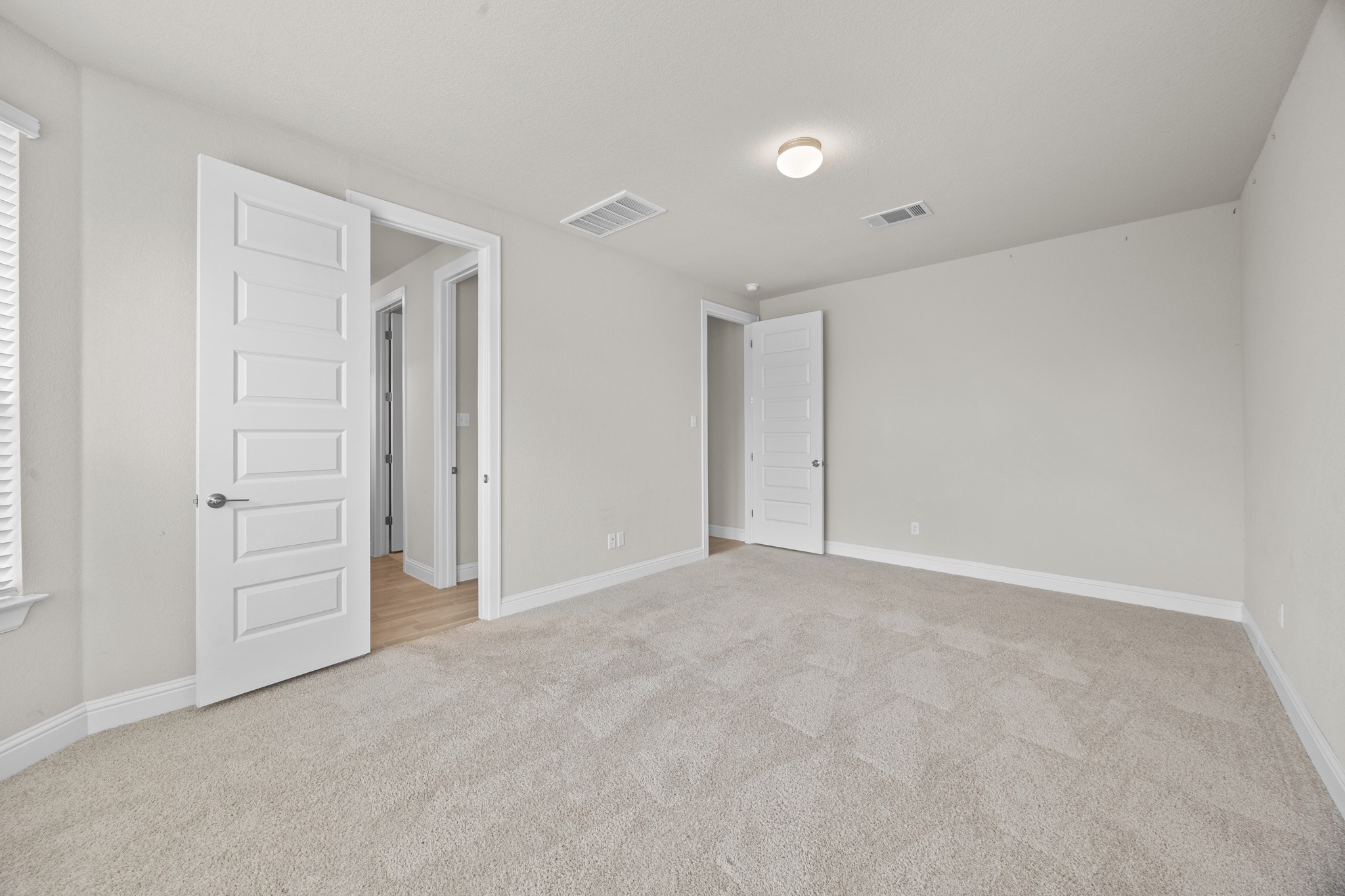 213 Graver Street Georgetown, TX 78626 - Photo 16 of 33 A spacious, naturally illuminated room featuring plush carpeting and pristine white trim, awaiting personal touches.