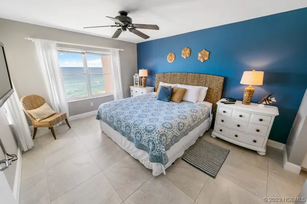 a bedroom with a bed a couch and a window