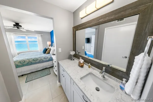 a bathroom with a tub sink and mirror