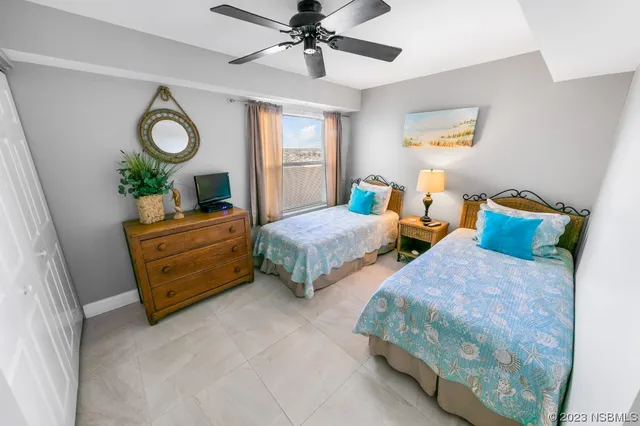 a bedroom with two beds and a chandelier