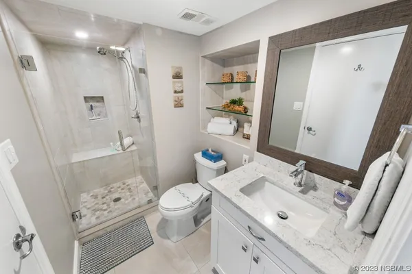a bathroom with a sink toilet tub and shower
