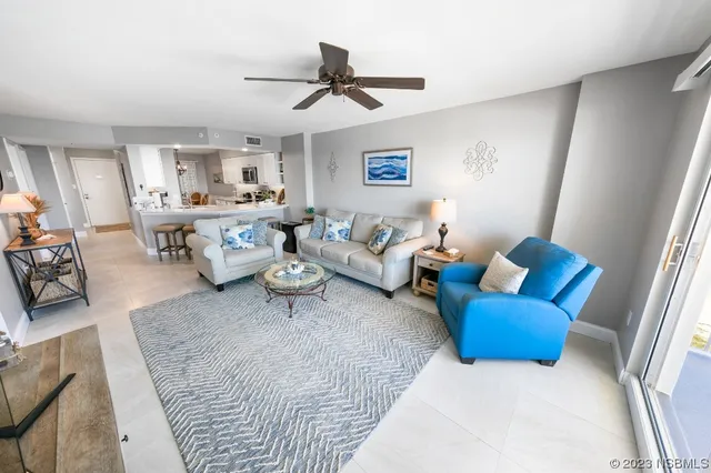 a living room with furniture and a ceiling fan