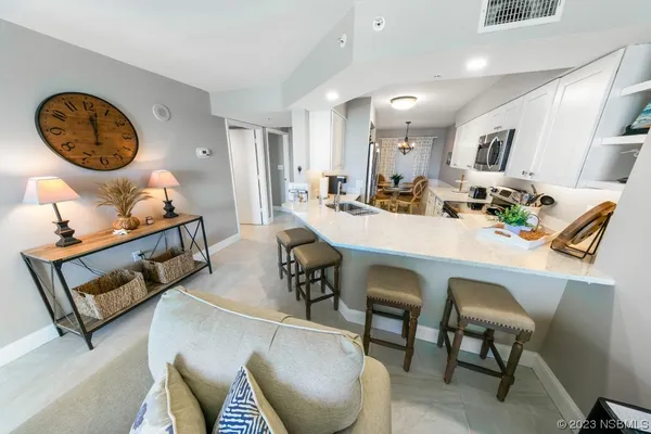 a view of a dining room with furniture and a chandelier