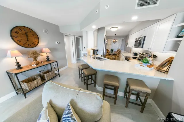 a view of a dining room with furniture and a chandelier
