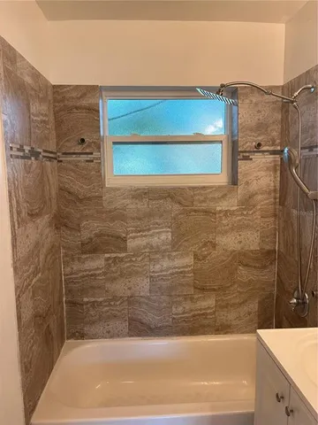 a bathroom with a bathtub and shower