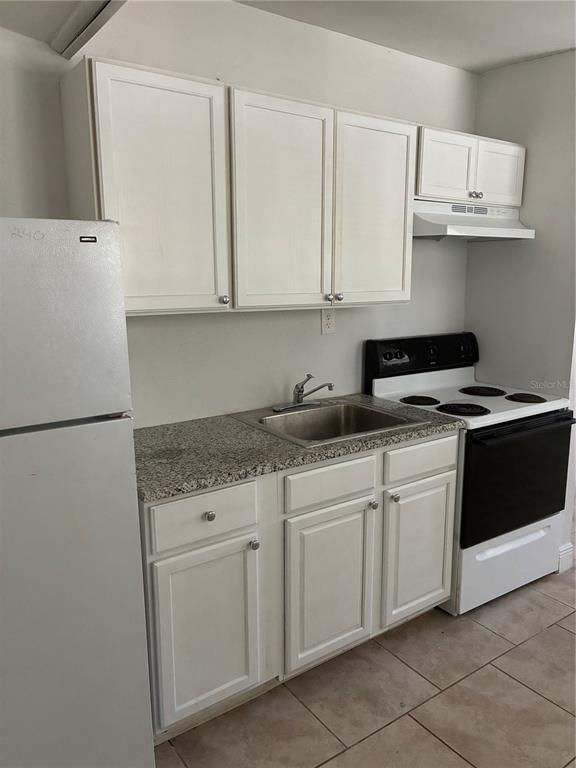1500 Daroca Drive Deltona, FL 32725 - Photo 20 of 22 a kitchen with stainless steel appliances granite countertop a sink and a stove