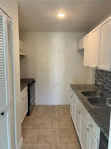 a kitchen that has a sink and a stove